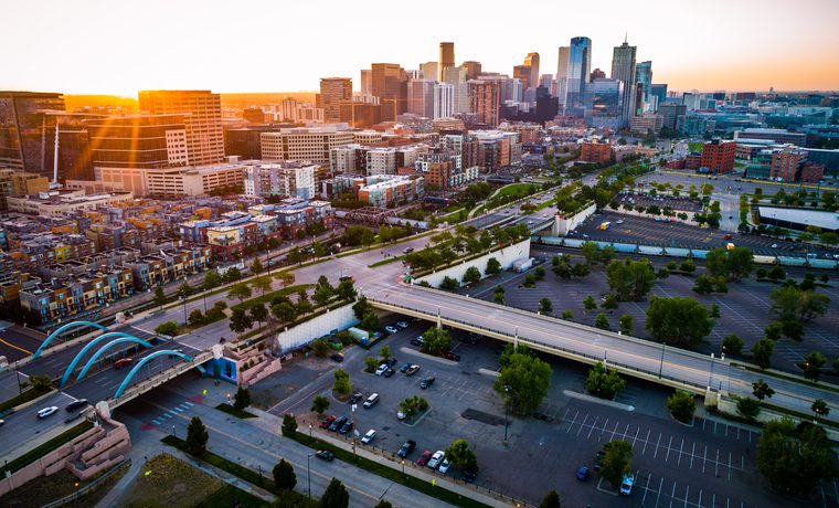 aerial drone view Sun beams and Sun rays beaming across horizon in Perfect Denver Colorado Skyline Cityscape high above Mile High City