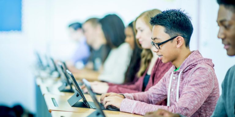Image of students working on tablet computers.