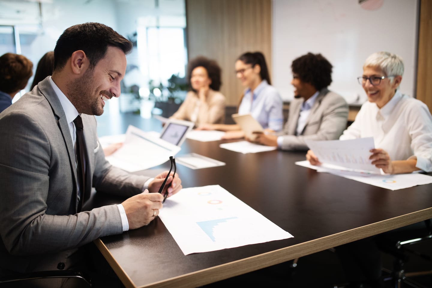 Group of business people sitting around a table.